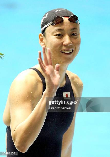 Tomoko Hagiwara waves to the fans after competing in the Women's 100m Medley Final during the day two of the FINA/ARENA Swimming World Cup 2010 -...