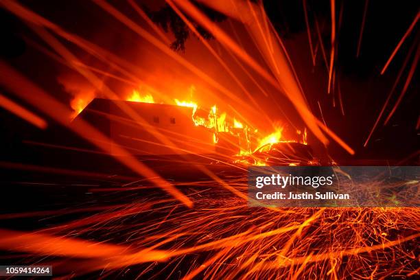 Embers blow in the wind as a Camp Fire burns a KFC restaurant on November 8, 2018 in Paradise, California. Fueled by high winds and low humidity, the...