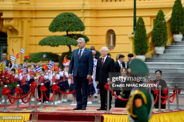 Cuba's President Miguel Diaz-Canel and his Vietnamese counterpart Nguyen Phu Trong review a guard of honor during a welcoming ceremony at the...