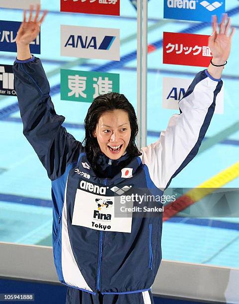 Aya Terakawa waves to the fans at the Women's 100m Backstroke award ceremony during the day two of the FINA/ARENA Swimming World Cup 2010 - Tokyo at...