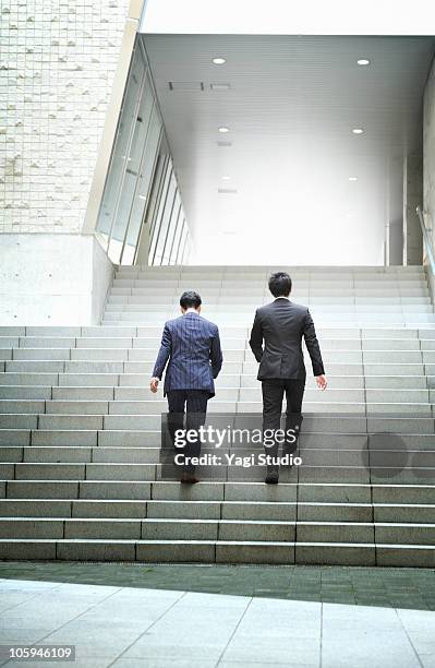 two office workers who go up the stairs  - steps and staircases bildbanksfoton och bilder