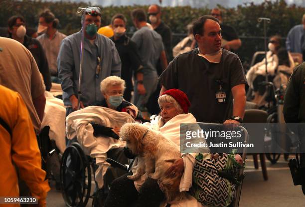 Hospital workers and first responders evacuate patients from the Feather River Hospital as the Camp Fire moves through the area on November 8, 2018...
