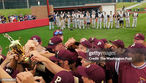 In background, Potomac Falls Baseball team watches as Poquoson receives the first place 2010 VHSL Baseball Group AA Trophy in Radford, VA., on June...