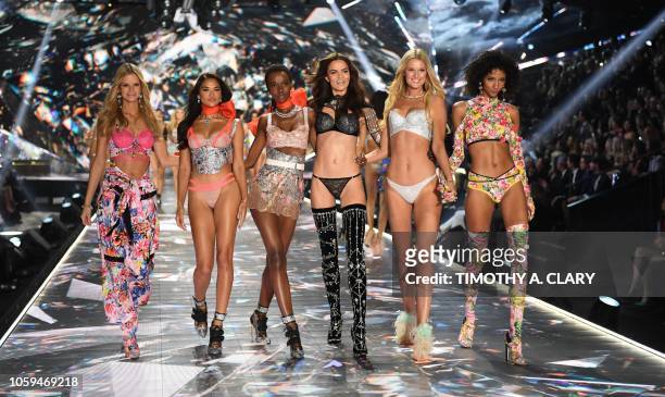 Models Nadine Leopold, Shanina Shaik, Herieth Paul, Barbara Fialho, Toni Garrn, and Aiden Curtiss walk the runway at the 2018 Victoria's Secret...