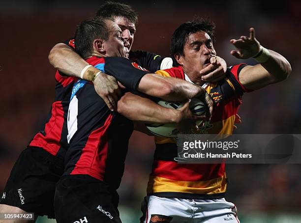 Trent Renata of Waikato is hit hard by Colin Slade and Willi Heinz of Canterbury during the round 13 ITM Cup match between Waikato and Canterbury at...
