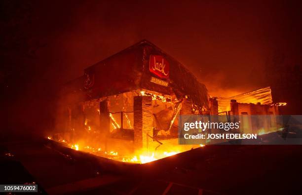 Jack In The Box fast food restaurant burns as the Camp fire tears through Paradise, north of Sacramento, California on November 08, 2018. More than...