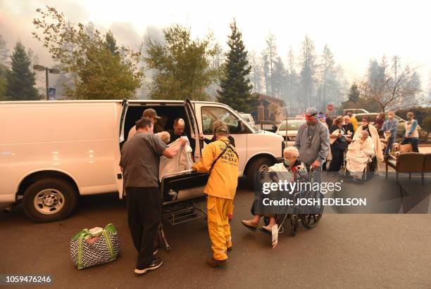 Search and rescue teams scramble to evacuate patients as the Feather River Hospital burns during the Camp fire in Paradise, California, on November...