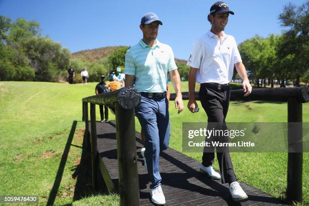 Rory McIlroy of Northern Ireland and Renato Paratore of Italy walk on the 4th green during the second round of the Nedbank Golf Challenge at Gary...