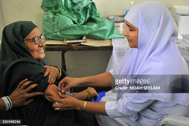 An Indian health worker administers a meningococcal polysaccharide vaccine to a Haj pilgrim in Hyderabad on October 22 as she prepares to depart for...