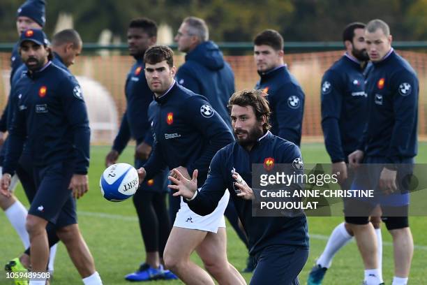France's Maxime Medard receives the ball as he attends the training session on November 9, 2018 in Marcoussis, southern Paris during the captain's...