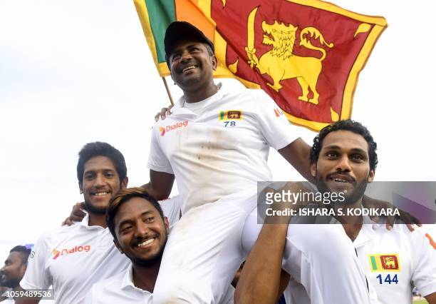 Sri Lanka's Rangana Herath is carried off the field by teammates after England won the opening Test cricket match against Sri Lanka at the Galle...