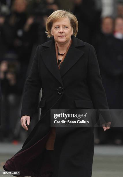 German Chancellor Angela Merkel walks across the courtyard of the Chancellery ahead of the arrival of Chilean President Sebastian Pinera on October...