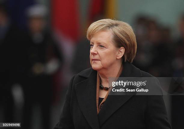 German Chancellor Angela Merkel walks across the courtyard of the Chancellery ahead of the arrival of Chilean President Sebastian Pinera on October...