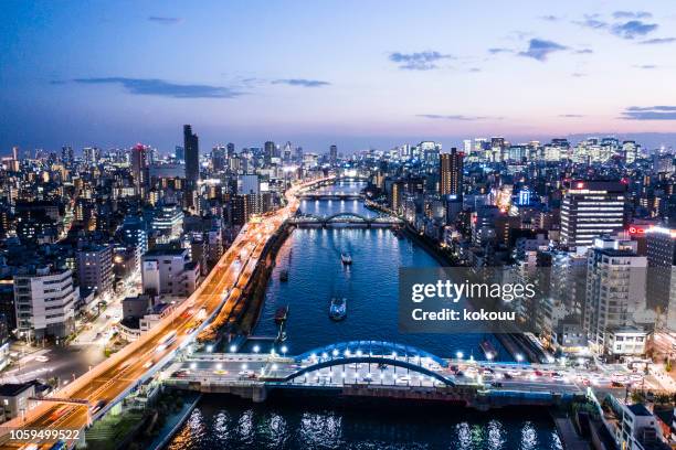 tokyo cityscape where night view and river can be seen - time of day stock pictures, royalty-free photos & images