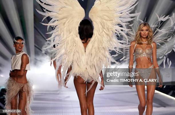 Swedish model Elsa Hosk walks the runway past singer Halsey as she performs at the 2018 Victoria's Secret Fashion Show on November 8, 2018 at Pier 94...