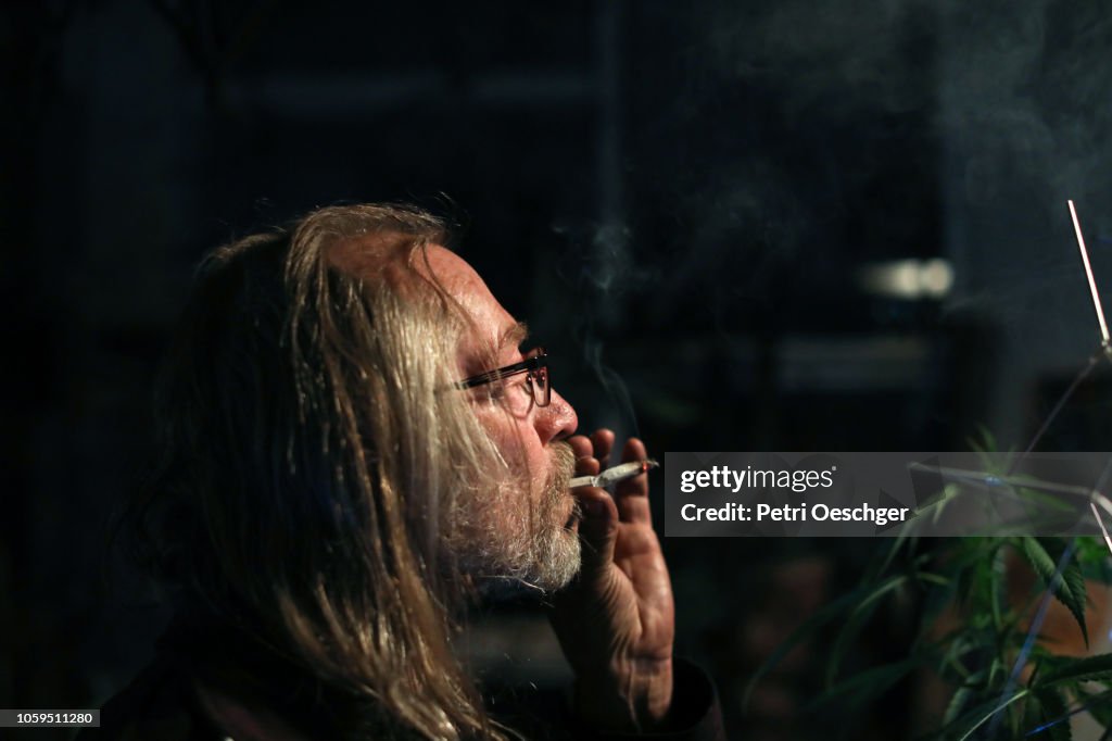 A Senior man smoking a marijuana joint.
