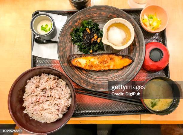 view directly above of charcoal grilled barrelfish seasoned in soy sauce and rice malt set meal - kelp stock-fotos und bilder