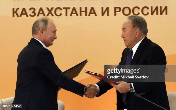 Russian President Vladimir Putin and Kazakh President Nursultan Nazarbayev exchange documents during the 15th Forum of Interregional Cooperation of...