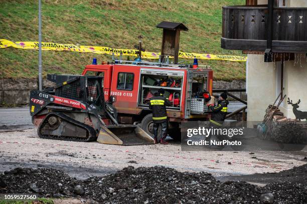 An escavator clearing up a road in disaster-hit in the city of Rocca Pietore, italian Dolomites, Belluno Province, with the Serrai di Sottoguda...