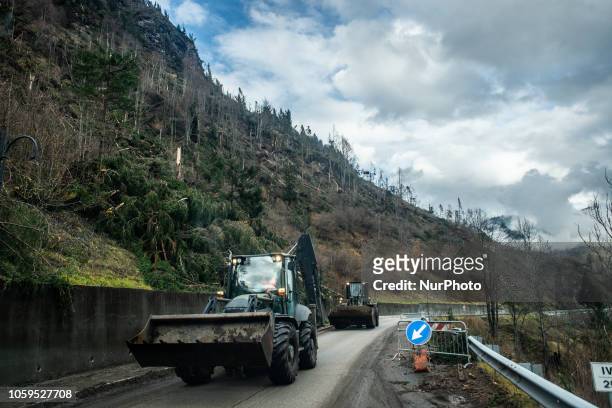 Escavators clearing up a road in disaster-hit in the Dolomites Mountains of Colle Santa Lucia, Belluno Province, in Italy, destroyed and torn by bad...