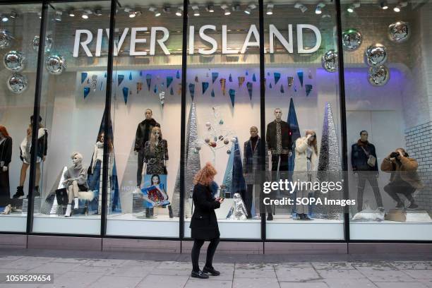 Shoppers are seen outside River Island store on London's Oxford Street. The retail sector faces difficulties as consumers cut down on spending and do...