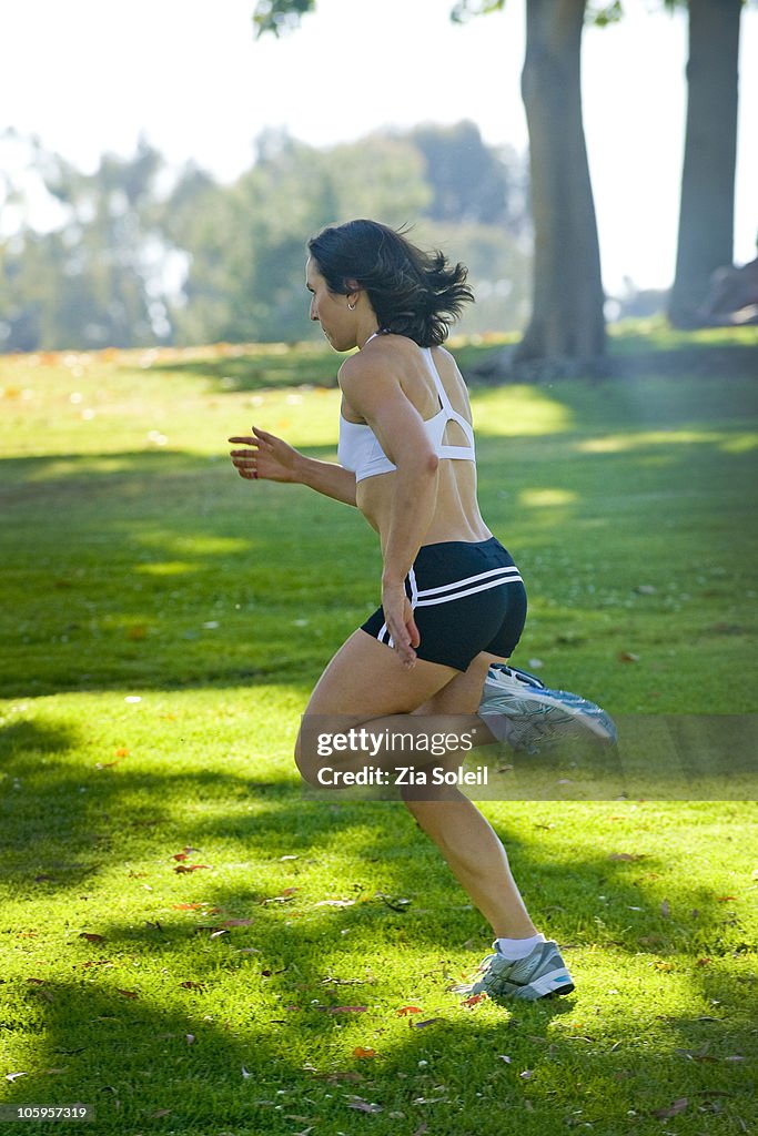 Fit young woman running in park