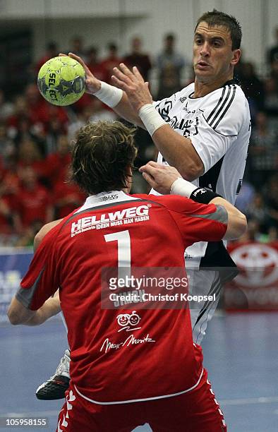 Andreas Simon of Ahlen-Hamm challenges Momir Ilic of Kiel during the Toyota Handball Bundesliga match between HSG Ahlen-Hamm and THW Kiel at the...