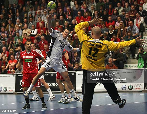Dominik Klein of Kiel scores a goal against Srdjan Djordjevic of Ahlen-Hamm during the Toyota Handball Bundesliga match between HSG Ahlen-Hamm and...