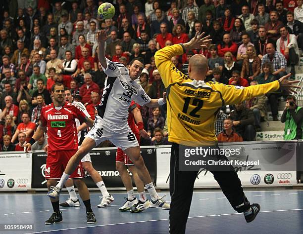 Dominik Klein of Kiel scores a goal against Srdjan Djordjevic of Ahlen-Hamm during the Toyota Handball Bundesliga match between HSG Ahlen-Hamm and...