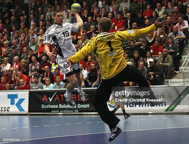 Tobias Reichmann of Kiel scores a goal against Carsten Schroeder of Ahlen-Hamm during the Toyota Handball Bundesliga match between HSG Ahlen-Hamm and...