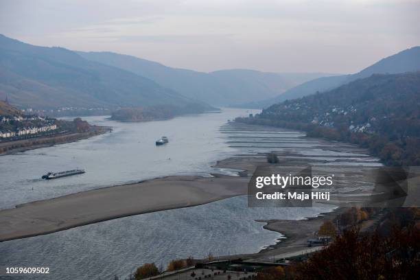 Cargo ships maneuver near the the banks of Rhine River on November 09, 2018 near Kaub in Germany. Summer heat wave in Germany as well unfavorable...