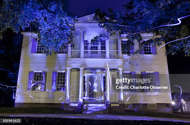 Composite image of multiple 30 second exposures of the Modecai House illuminated with LED lights. Built in 1785, this is the oldest home on its...