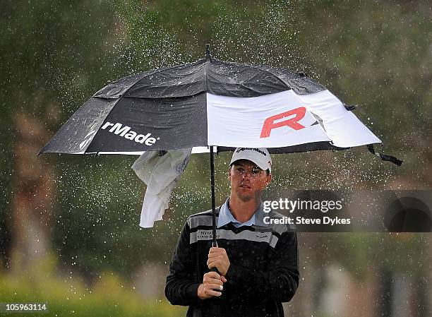 John Mallinger shakes the water off of his umbrella on the 7th hole during the second round of the Justin Timberlake Shriners Hospitals for Children...