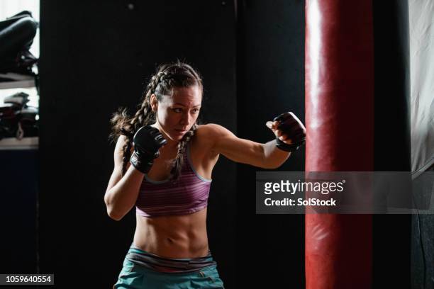 powerful female boxer - mixed martial arts stock pictures, royalty-free photos & images