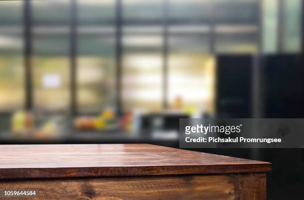 close-up of empty wooden table at office - table foto e immagini stock