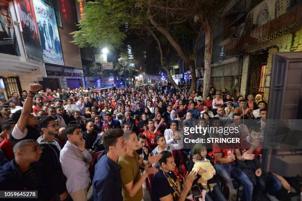 Egyptian Al-Ahly fans watch the CAF Champions League second leg final football match between Egypt's Al-Ahly and Tunisia's ES Tunis on street...