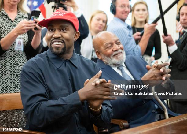 View of American rapper and producer Kanye West and retired professional football player Jim Brown, in the White House's Oval Office, Washington DC,...