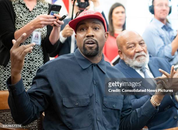 View of American rapper and producer Kanye West, gesturing with his hands, in the White House's Oval Office, Washington DC, October 11, 2018. He...