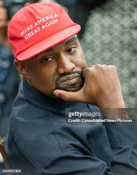 View of American rapper and producer Kanye West, his chin in his hand, in the White House's Oval Office, Washington DC, October 11, 2018. He wears a...