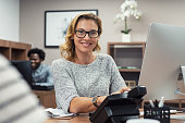 Mature casual woman working on computer