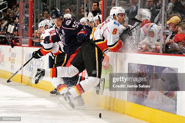 Cory Sarich of the Calgary Flames hits the boards after missing a check on Antoine Vermette of the Columbus Blue Jackets during the first period on...