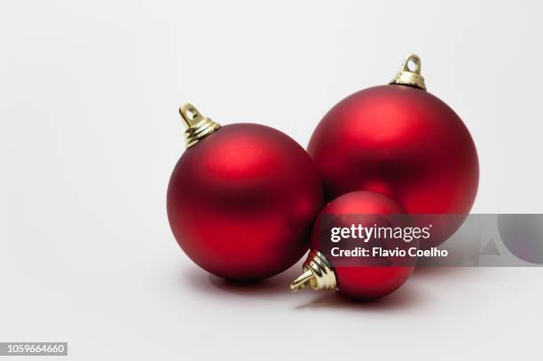 three christmas baubles on white background - christmas bulbs stock pictures, royalty-free photos & images