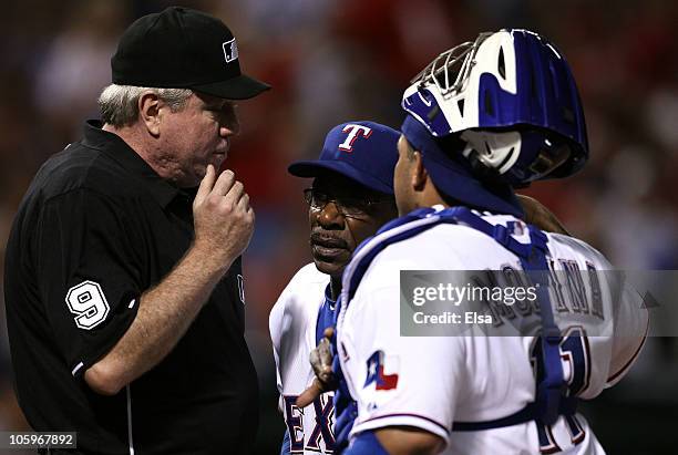 Bengie Molina of the Texas Rangers and Manager Ron Washington argue a call with umpire Brian Groman during Game Six of the ALCS against the New York...