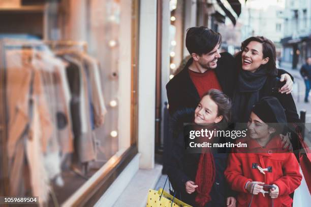 family on christmas shopping - black friday sale stock pictures, royalty-free photos & images