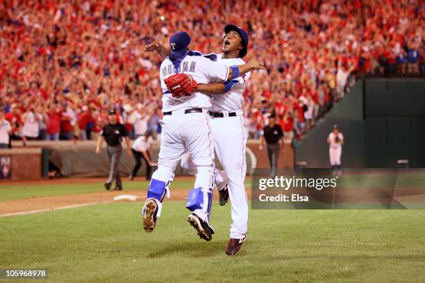 Bengie Molina and Neftali Feliz of the Texas Rangers celebrate after defeating the New York Yankees 6-1 in Game Six of the ALCS to advance to the...