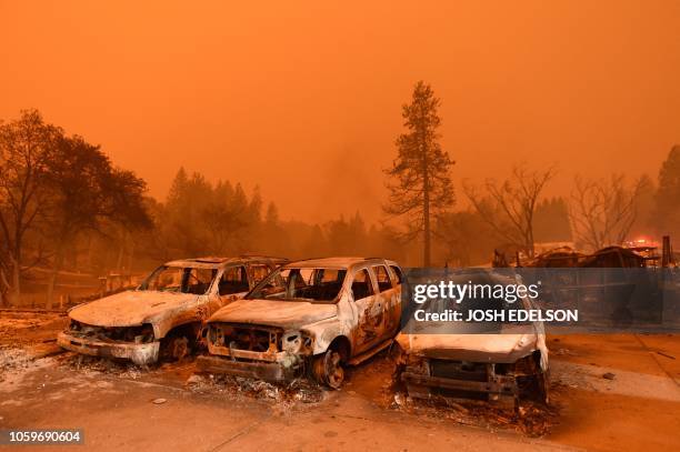 Abandoned vehicles sit at a car lot in Paradise, north of Sacramento, California on November 09, 2018. A rapidly spreading, late-season wildfire in...