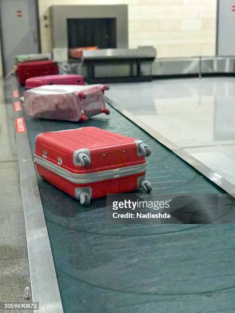 suitcases at airport - baggage claim stock pictures, royalty-free photos & images