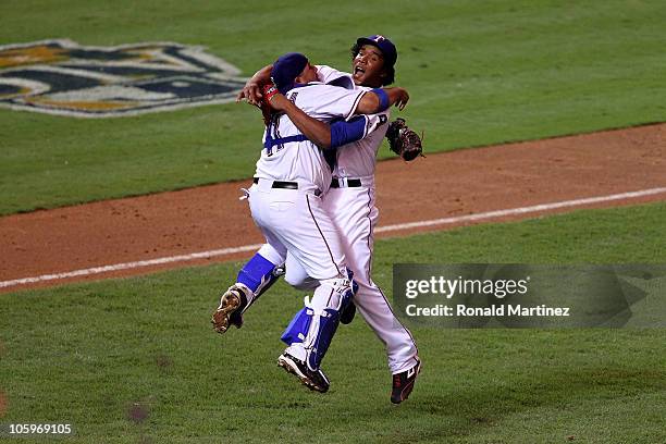 Bengie Molina and Neftali Feliz of the Texas Rangers celebrate after defeating the New York Yankees 6-1 in Game Six of the ALCS to advance to the...