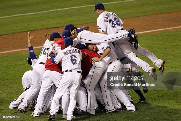 Josh Hamilton of the Texas Rangers jumps on top of his teammates as they celebrate after defeating the New York Yankees 6-1 in Game Six of the ALCS...