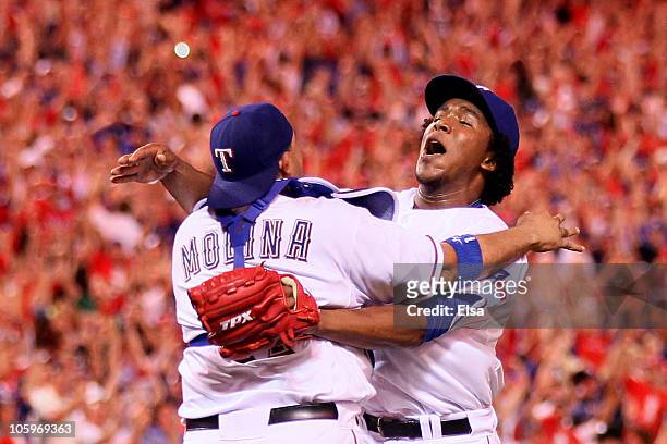 Bengie Molina and Neftali Feliz of the Texas Rangers celebrate after defeating the New York Yankees 6-1 in Game Six of the ALCS to advance to the...